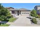 Charming single-Gathering home with well-manicured lawn, a two-car garage, and inviting front porch at 802 Eva Peak Dr, Erie, CO 80516