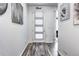 Bright entryway featuring stylish flooring, tasteful wall decor and a door with built-in blinds at 802 Eva Peak Dr, Erie, CO 80516