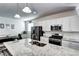 Bright kitchen featuring granite countertops, modern appliances, and a central island with ample workspace at 802 Eva Peak Dr, Erie, CO 80516