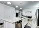 Bright kitchen island with granite countertops, stainless steel appliances, and modern pendant lighting at 802 Eva Peak Dr, Erie, CO 80516
