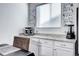 Kitchen counter area with small appliances, white cabinets, light countertops, and a window for natural light at 802 Eva Peak Dr, Erie, CO 80516