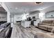Open-concept living space featuring modern kitchen, dining area, and comfortable living room at 802 Eva Peak Dr, Erie, CO 80516