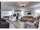 Spacious open layout featuring a modern kitchen with island, dining area, and a cozy living space at 802 Eva Peak Dr, Erie, CO 80516