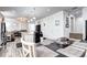 Open-concept living space with kitchen island, dining area, and comfortable seating, seamlessly connected at 802 Eva Peak Dr, Erie, CO 80516