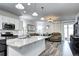 Stylish open floor plan with kitchen island, modern appliances, and a cozy living area with comfortable seating at 802 Eva Peak Dr, Erie, CO 80516