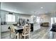 Inviting living space featuring an open layout with a kitchen island, dining area, and comfortable seating at 802 Eva Peak Dr, Erie, CO 80516