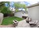 Backyard featuring a stone patio with outdoor furniture and a charming fire pit on a green lawn at 1385 Birch St, Denver, CO 80220