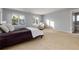 Bedroom featuring neutral walls, carpet flooring, large windows, and a comfortable armchair at 1385 Birch St, Denver, CO 80220