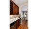Butler pantry with custom cabinetry, quartz countertops, and a wine rack at 1385 Birch St, Denver, CO 80220