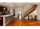 Open-concept kitchen and entryway with hardwood floors and staircase at 1385 Birch St, Denver, CO 80220