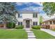 Inviting two-story home with manicured lawn, stepping stone path, and attractive curb appeal at 1385 Birch St, Denver, CO 80220