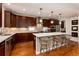 Spacious kitchen featuring a large island with bar seating, custom cabinetry, and modern appliances at 1385 Birch St, Denver, CO 80220