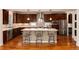 Modern kitchen featuring a large island, stainless steel appliances, and pendant lighting at 1385 Birch St, Denver, CO 80220