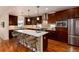Gourmet kitchen with a center island, stainless steel appliances, and custom cabinetry at 1385 Birch St, Denver, CO 80220