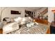 Open living room with hardwood floors, a stylish rug, a cozy couch and easy access to the kitchen at 1385 Birch St, Denver, CO 80220