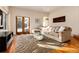 Bright living room with hardwood floors, stylish rug, modern lighting, and a comfortable seating area at 1385 Birch St, Denver, CO 80220