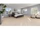 Large main bedroom with big windows offering ample natural light and a comfortable seating area at 1385 Birch St, Denver, CO 80220