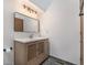 Bathroom featuring a modern vanity, white countertop, framed mirror and lighting fixture at 1919 Newland Ct, Lakewood, CO 80214