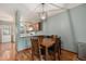 Bright dining area adjoining kitchen with stylish pendant lighting and hardwood flooring at 1919 Newland Ct, Lakewood, CO 80214