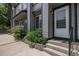 Charming townhome entrance with well-kept greenery, and a welcoming front door at 1919 Newland Ct, Lakewood, CO 80214