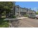 Attractive townhome featuring a gray exterior, front parking, and well-maintained landscaping at 1919 Newland Ct, Lakewood, CO 80214