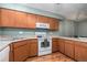 Functional kitchen with wood cabinets, standard appliances, and efficient layout at 1919 Newland Ct, Lakewood, CO 80214