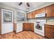 Traditional kitchen features wood cabinets, laminate countertops, and white appliances at 1919 Newland Ct, Lakewood, CO 80214