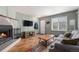 Inviting living room featuring fireplace, wood flooring, and light-filled space at 1919 Newland Ct, Lakewood, CO 80214