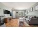 Inviting living room features wood floors, a comfortable sofa, and natural light at 1919 Newland Ct, Lakewood, CO 80214