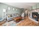 Open-concept living room with stairs, fireplace, and a comfortable seating area at 1919 Newland Ct, Lakewood, CO 80214