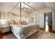 Cozy bedroom featuring a four poster bed, soft rug and neutral decor at 2431 N Ogden St, Denver, CO 80205