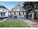 Two-story home with a blue facade and a large porch at 2431 N Ogden St, Denver, CO 80205