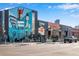 Street view of a commercial building featuring colorful murals and business storefronts at 2431 N Ogden St, Denver, CO 80205
