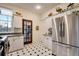 Bright kitchen featuring stainless steel appliances, granite countertops, and black and white tile at 2431 N Ogden St, Denver, CO 80205