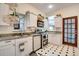 Well-lit kitchen features stainless steel appliances, granite countertops, and black and white tile at 2431 N Ogden St, Denver, CO 80205
