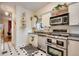 Galley kitchen featuring stainless steel appliances and black and white tile flooring at 2431 N Ogden St, Denver, CO 80205