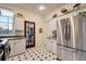 Updated kitchen with stainless steel appliances and French doors leading outside at 2431 N Ogden St, Denver, CO 80205