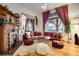 Inviting living room featuring an orange sectional sofa, hardwood floors, and a decorative fireplace at 2431 N Ogden St, Denver, CO 80205