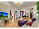 Bright living room features hardwood floors, a large television, and an open floor plan at 2431 N Ogden St, Denver, CO 80205