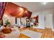 Unique living room area with a circular sofa, hardwood floors, and elegant curtains at 2431 N Ogden St, Denver, CO 80205