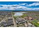 Panoramic aerial view of the neighborhood featuring mature trees, a serene lake, and mountain views at 1717 Irving St, Denver, CO 80204
