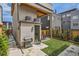Private backyard featuring a grill, small lawn, and manicured trees at 1717 Irving St, Denver, CO 80204