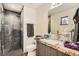 Modern bathroom with a walk-in shower and granite countertop at 1717 Irving St, Denver, CO 80204