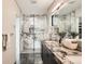 Modern bathroom with a glass shower featuring beautiful marble tile and a double sink vanity with stone countertop at 1717 Irving St, Denver, CO 80204