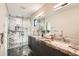 Modern bathroom with a glass shower featuring beautiful marble tile and a double sink vanity with stone countertop at 1717 Irving St, Denver, CO 80204
