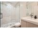 Modern bathroom features a sleek glass-enclosed shower with marble tile and updated fixtures at 1717 Irving St, Denver, CO 80204