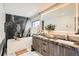 A luxury bathroom with a modern tub, double sink vanity with stone countertop, and marble accents at 1717 Irving St, Denver, CO 80204