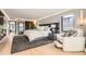 Spacious bedroom with stylish decor including hardwood floors, modern lighting, and a cozy seating area at 1717 Irving St, Denver, CO 80204