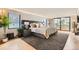 Bright and airy bedroom with hardwood floors, a large bed, modern lamps, and a view of the outside at 1717 Irving St, Denver, CO 80204