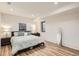 Spacious bedroom with modern decor, including stylish furniture, neutral colors, and a wooden floor at 1717 Irving St, Denver, CO 80204